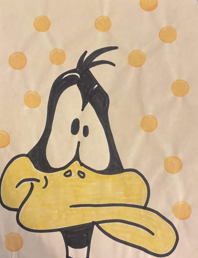Colored drawing of Daffy Duck on a yellow polka-dot background