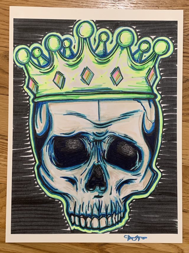 Crowned skull drawing in blue, green, and black