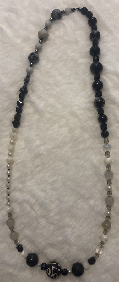 Black and white beaded necklace with ceramic focal bead