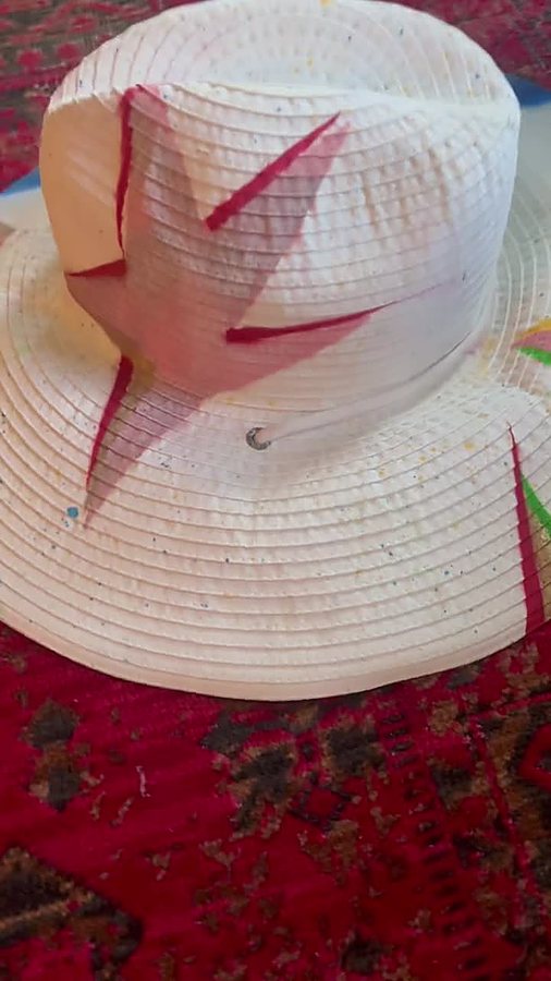 Close-up of a white beach hat with hand-painted star designs