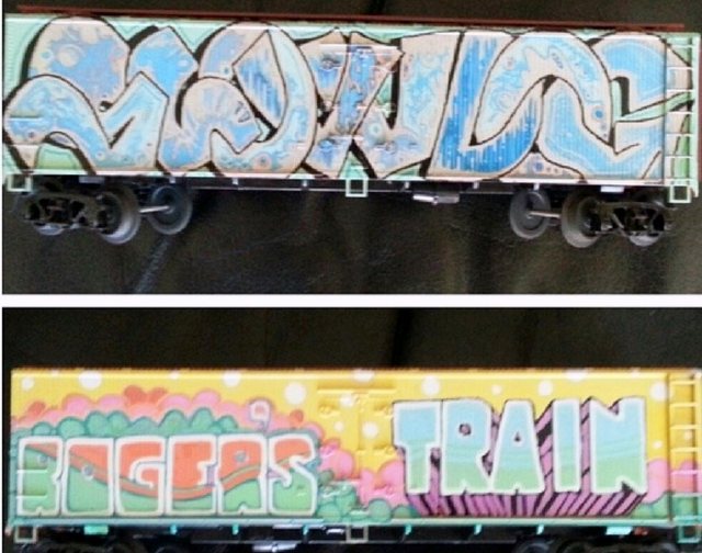 Two painted Lionel train cars with graffiti lettering